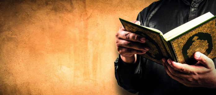Koran,In,Hand,-,Holy,Book,Of,Muslims,(,Public