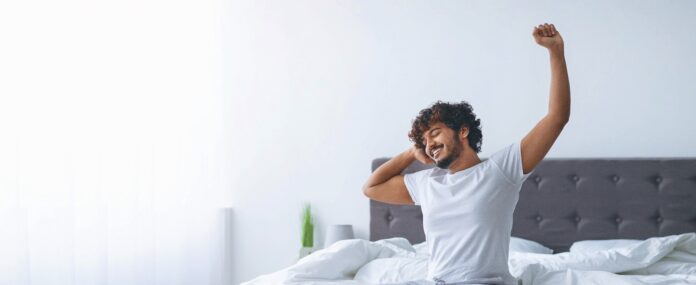 Morning Routine Starts With Stretching in a Bright Bedroom